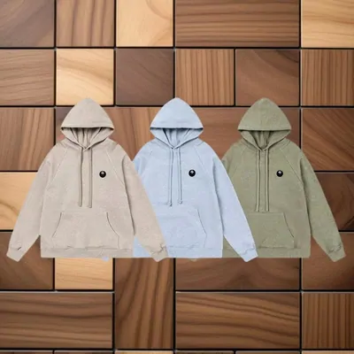 Three pullover hoodies in oatmeal, pale blue and sage with a small chest patch